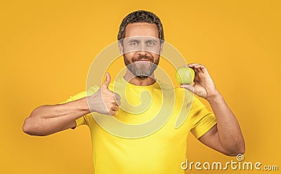 healthy man with vitamin fruit isolated on yellow, thumb up. healthy man with vitamin fruit Stock Photo