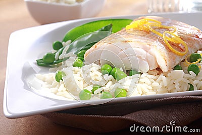 Healthy meal of baked fish, rice and peas Stock Photo