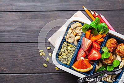 Healthy meal prep containers with beans meatballs, pasta, vegetables, berries, seeds and nuts in a container Stock Photo