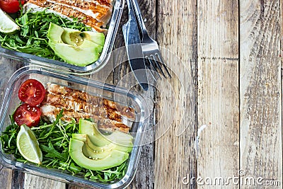 Healthy meal prep containers with rukola, turkey grill, tomatoes and avocado Stock Photo