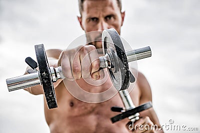 Healthy mind in a healthy body. Muscular man exercising with dumbbell. Dumbbell exercise. Dare to be great. Sportsman Stock Photo