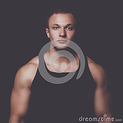 Healthy muscular young man. Isolated on black background Stock Photo