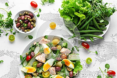 Healthy Nicoise salad with salmon, colourful sweet cherry tomatoes, olives, green beans, cucumber ribbons, soft boiled Stock Photo