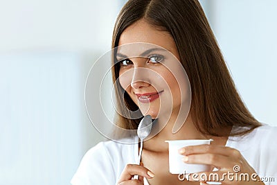 Healthy Nutrition. Beautiful Woman Eating Yogurt, Dairy Product Stock Photo