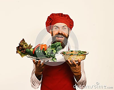 Healthy nutrition and cuisine concept. Chef holds potato and vegetables Stock Photo