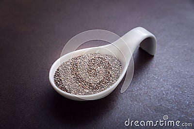 Healthy and Nutritious Chia Seeds in White Bowl on a Brown Background Stock Photo