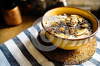 Healthy nutritious coconut whole grain oatmeal porridge breakfast with seed variety and orange peel.Fragrant and delicious morning Stock Photo