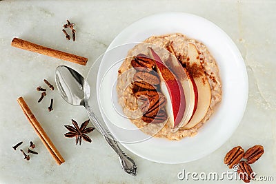 Healthy oatmeal with red pear, pecans and cinnamon, overhead scene Stock Photo