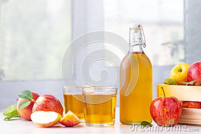 Healthy organic food. Apple cider vinegar or juice in glass bottle and fresh red apples. Stock Photo