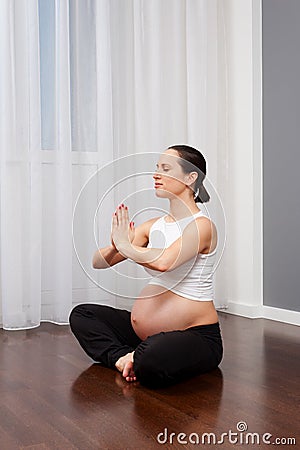 Healthy pegnant woman practicing yoga Stock Photo