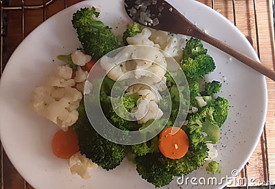 Other healthy plate with broccoli, carrots and cauliflower. Stock Photo