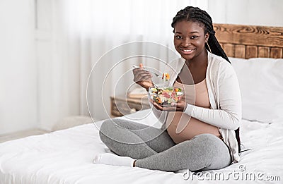 Healthy Pregnancy Nutrition. Happy Pregnant African American Woman Eating Fresh Vegetable Salad Stock Photo
