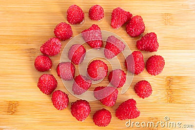 Healthy red raspberry fruits on chopping board Stock Photo