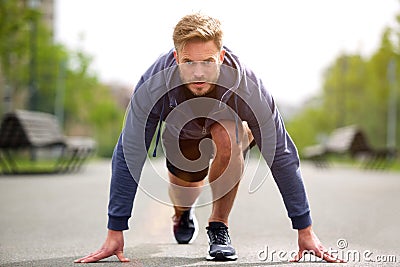 Healthy runner in starting position outside Stock Photo