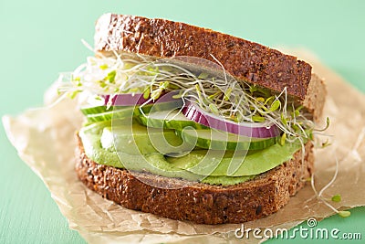 Healthy rye sandwich with avocado cucumber alfalfa sprouts Stock Photo