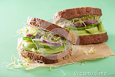 Healthy rye sandwich with avocado cucumber alfalfa sprouts Stock Photo