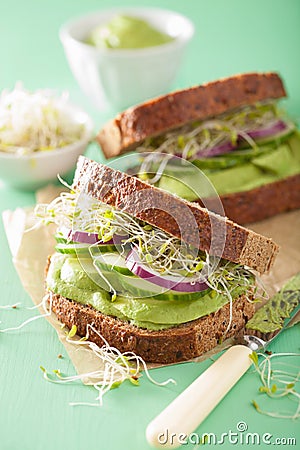 Healthy rye sandwich with avocado cucumber alfalfa sprouts Stock Photo