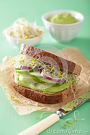 Healthy rye sandwich with avocado cucumber alfalfa sprouts Stock Photo