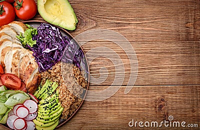 Healthy salad bowl with quinoa, chicken, avocado and vegetables . Stock Photo