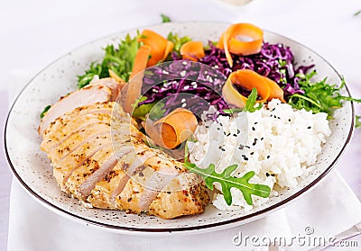 Healthy salad. Buddha bowl dish with chicken fillet, rice, red cabbage, carrot Stock Photo