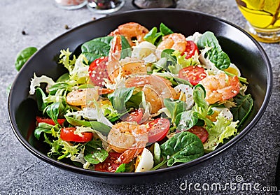 Healthy salad plate. Fresh seafood recipe. Grilled shrimps and fresh vegetable salad and egg. Grilled prawns. Stock Photo
