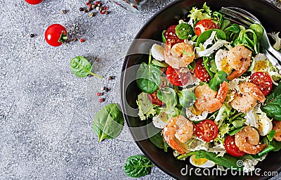 Healthy salad plate. Fresh seafood recipe. Grilled shrimps and fresh vegetable salad and egg. Grilled prawns. Healthy food. Flat l Stock Photo