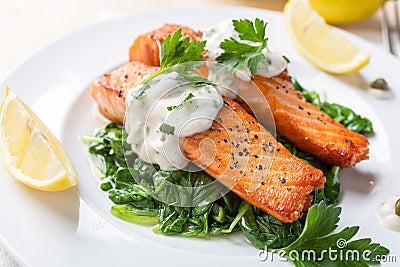 Healthy Salmon Steak on bed of spinach Stock Photo