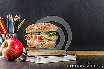 Healthy school food concept, lunch with apple, sandwich, books a Stock Photo