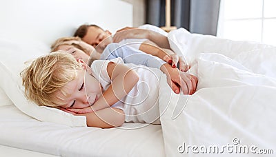 Healthy sleep. happy family parents and children sleeping in white bed Stock Photo