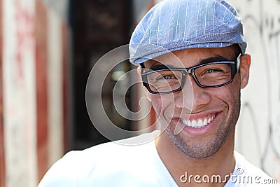 Healthy Smile. Teeth Whitening. Beautiful Smiling Young man Portrait close up. Over modern corridor background . Laughing Stock Photo