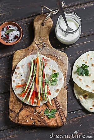 Healthy snack - fresh zucchini, carrots, sweet red pepper, natural yogurt, and a homemade tortilla Stock Photo