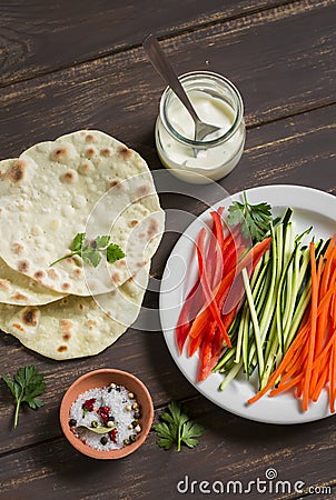 Healthy snack - fresh zucchini, carrots, sweet red pepper, natural yogurt, and a homemade tortilla Stock Photo