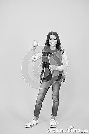 Healthy snack. Happy child hold apple and books. School snack. Snack break. Healthy eating and snacking. Vegetarian food Stock Photo