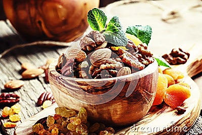 Healthy snack: raw nuts and dried fruit, decorated with mint. Vi Stock Photo