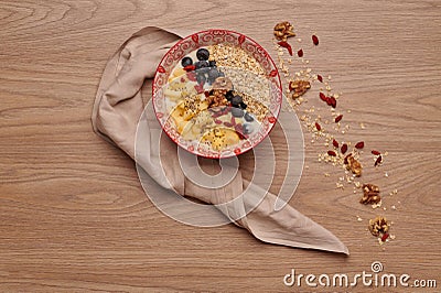 Healthy snacks in bowl: yoghurt, oat flakes, fruit, chia and goji seeds Stock Photo