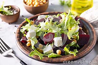 Healthy spring salad beet with spinach, cheese feta and chickpeas on a marble tabletop Stock Photo