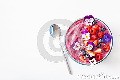 Healthy summer berry smoothie bowl with flowers and chia seed Stock Photo
