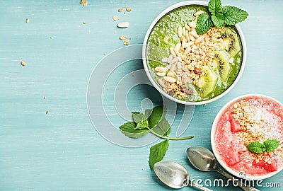 Healthy summer breakfast concept. Colorful fruit smoothie bowls on turquoise blue background Stock Photo