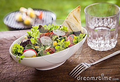 Healthy summer salad with a glass of fresh water Stock Photo