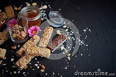 Healthy superfood composition. Various kinds granola energy protein bars with honey in jar Stock Photo