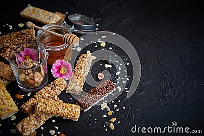 Healthy superfood composition. Various kinds granola energy protein bars with honey in jar Stock Photo