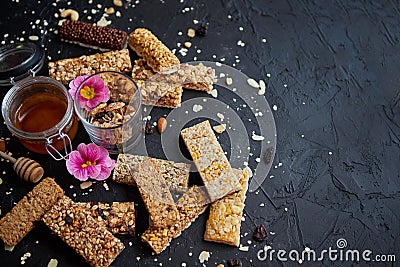 Healthy superfood composition. Various kinds granola energy protein bars with honey in jar Stock Photo