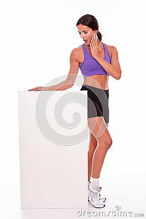 Healthy surprised brunette holding blank placard Stock Photo