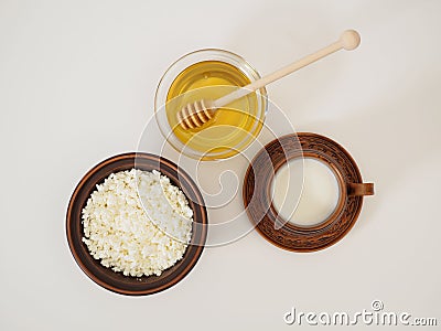 Healthy tasty breakfast in earthenware on a white background. Natural farm dairy products and fresh honey. Milk, cottage Stock Photo