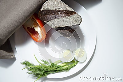 Rye bread, egg and pepper on a white background Stock Photo