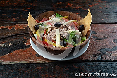 Healthy tuna salad on rustic wooden kitchen table Stock Photo