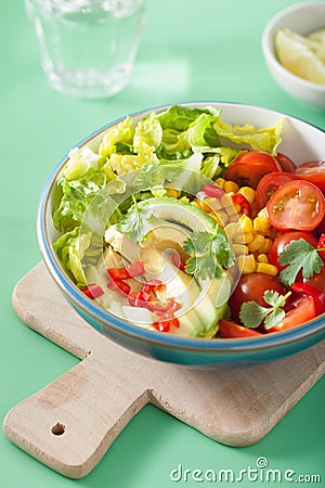 Healthy vegan avocado salad with tomatoes and sweetcorn Stock Photo