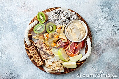 Healthy vegan dessert snacks - protein granola bars, homemade raw energy balls, cashew butter, toasted coconut chips Stock Photo