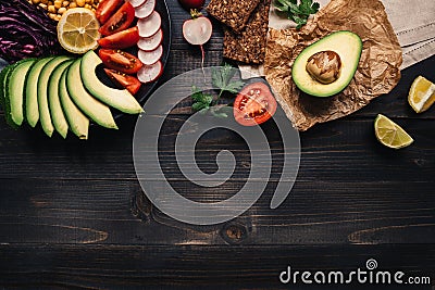 Healthy vegan food concept. Healthy food with vegetables and whole wheat bread on the wooden table top view. Copy space Stock Photo