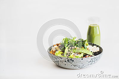 Healthy vegan superbowl with hummus and green smoothie Stock Photo